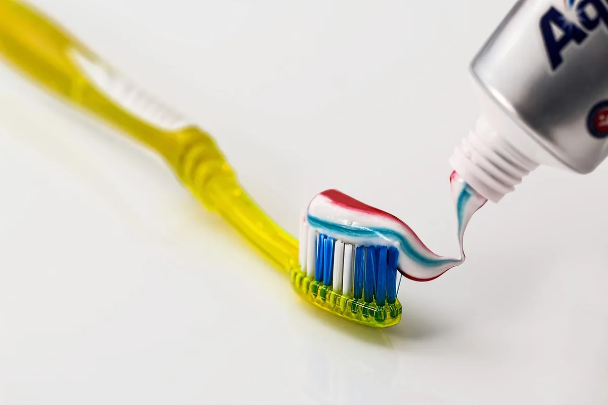 Brosse à dents avec mousse en train de brosser des dents