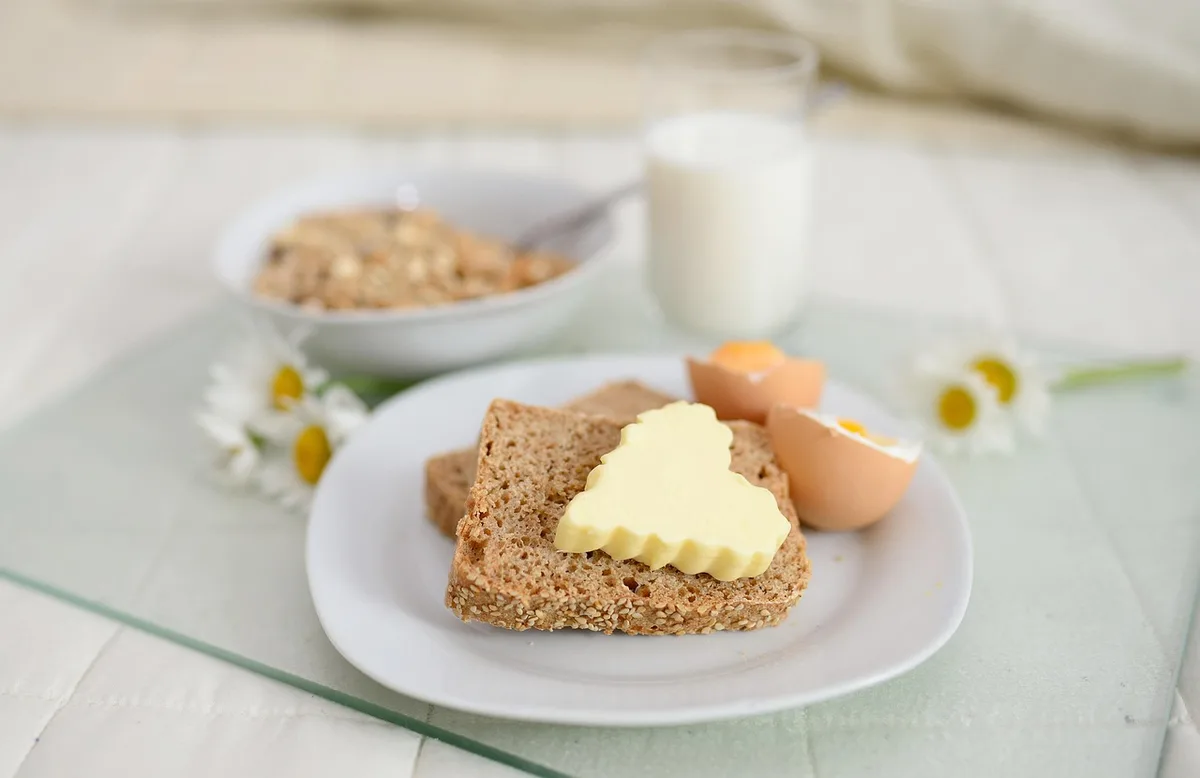 Viennoiseries et céréales sucrées sur une table montrant aliments à éviter au petit-déjeuner
