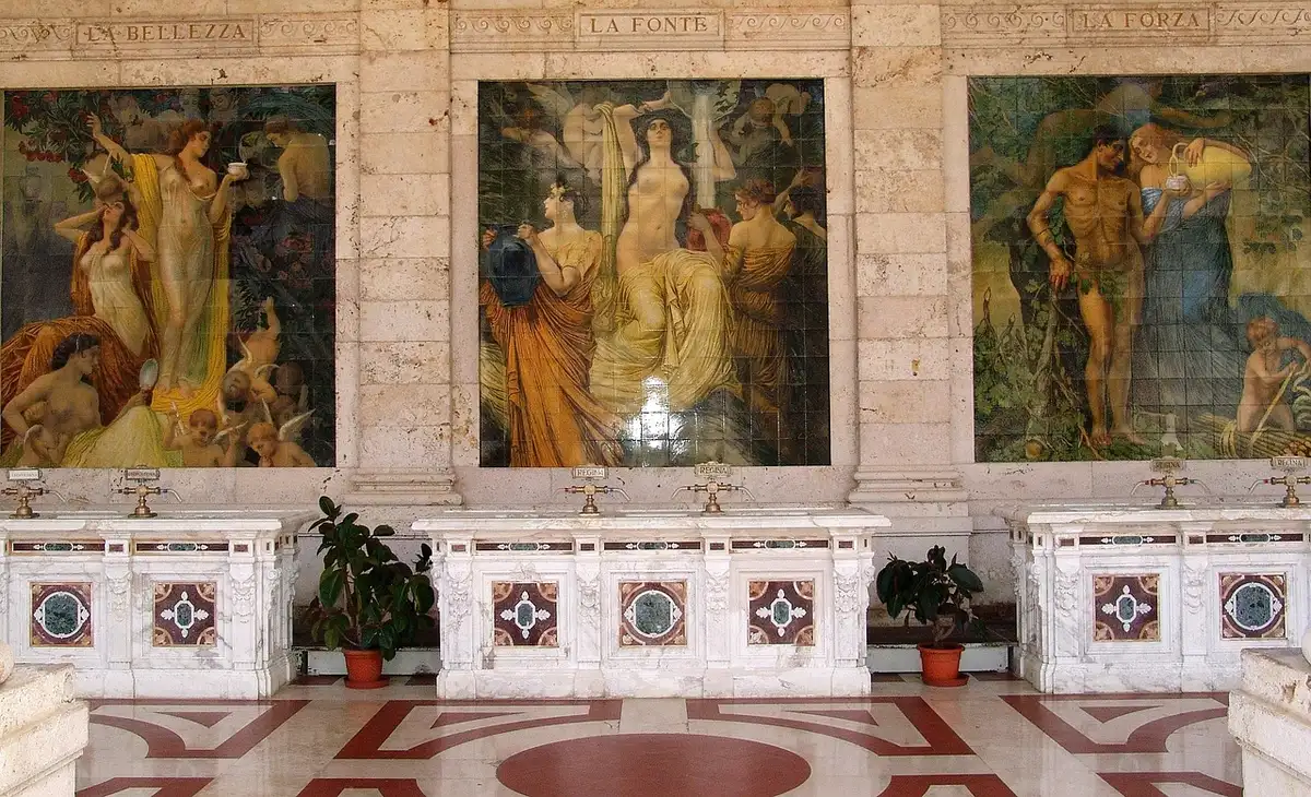 Hall lumineux d'une station thermale avec peignoirs et visiteur près d'un bassin
